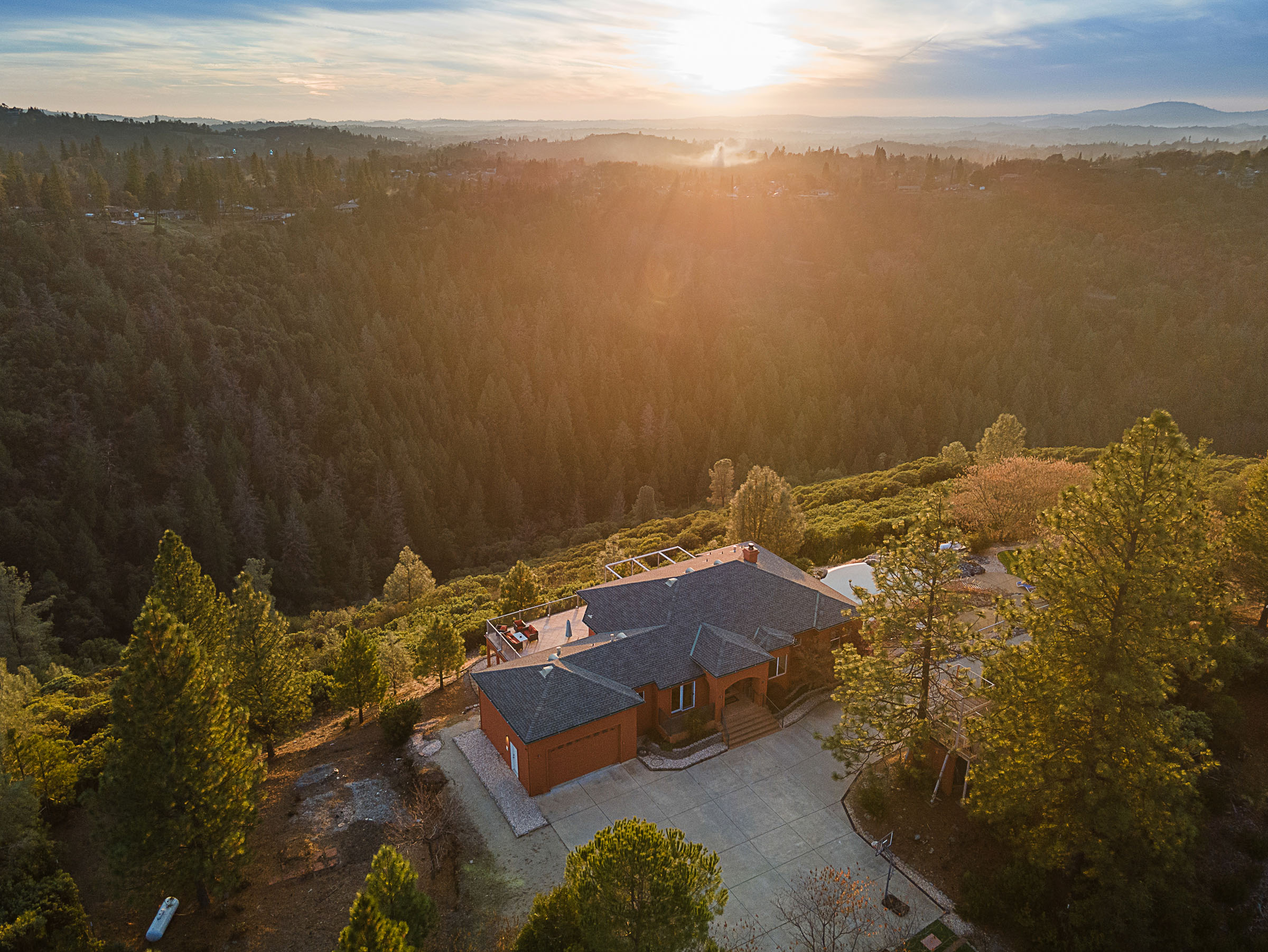 The residence perched above Big Canyon at sunset