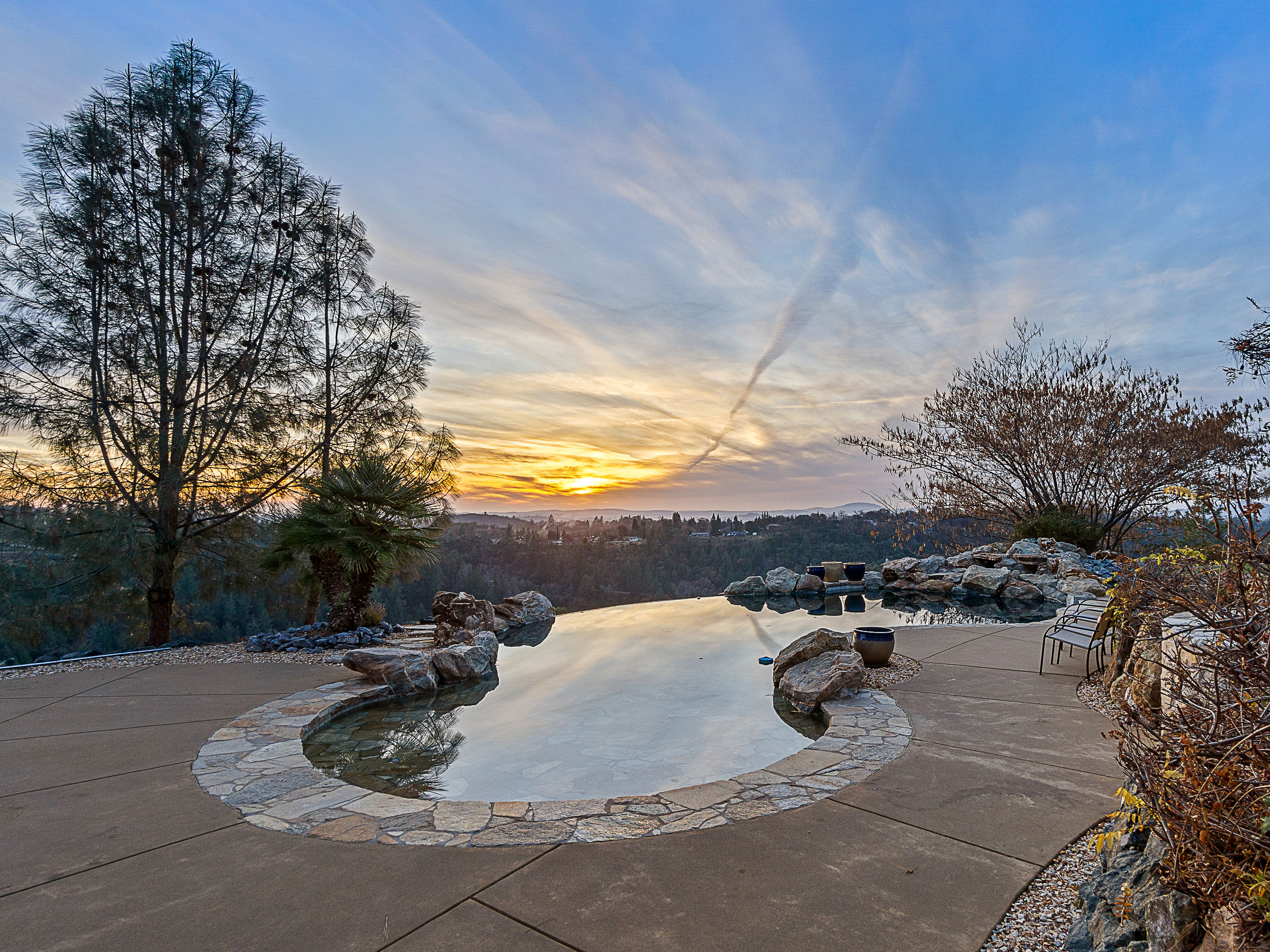 Infinity-edge pool reflecting the sunset above Big Canyon