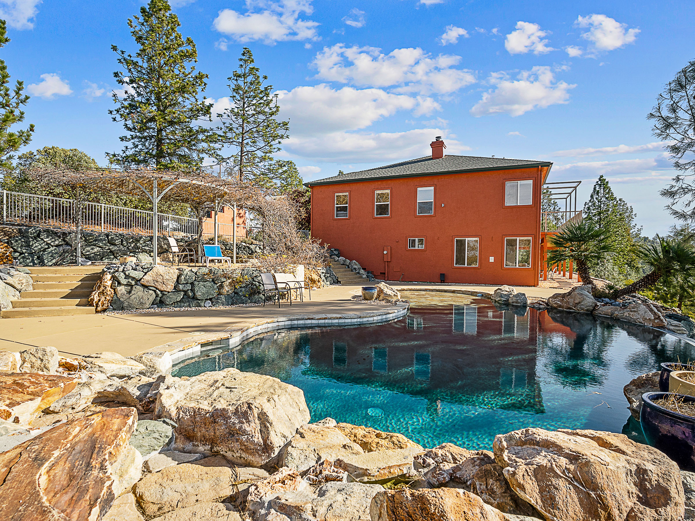 Pool, terrace and rear elevation of the residence